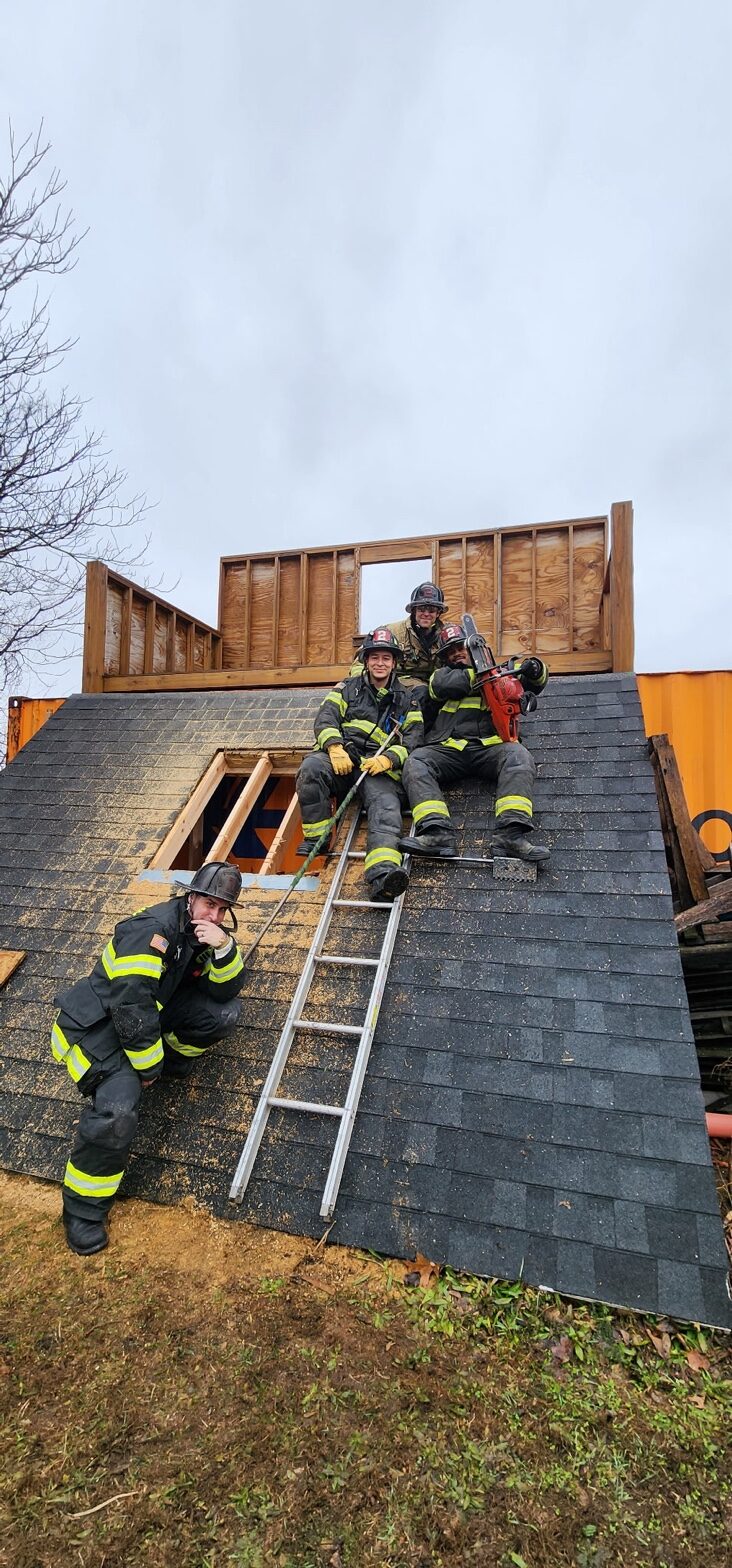 Firefighter crew on training roof prop with Rash Bar and saw
