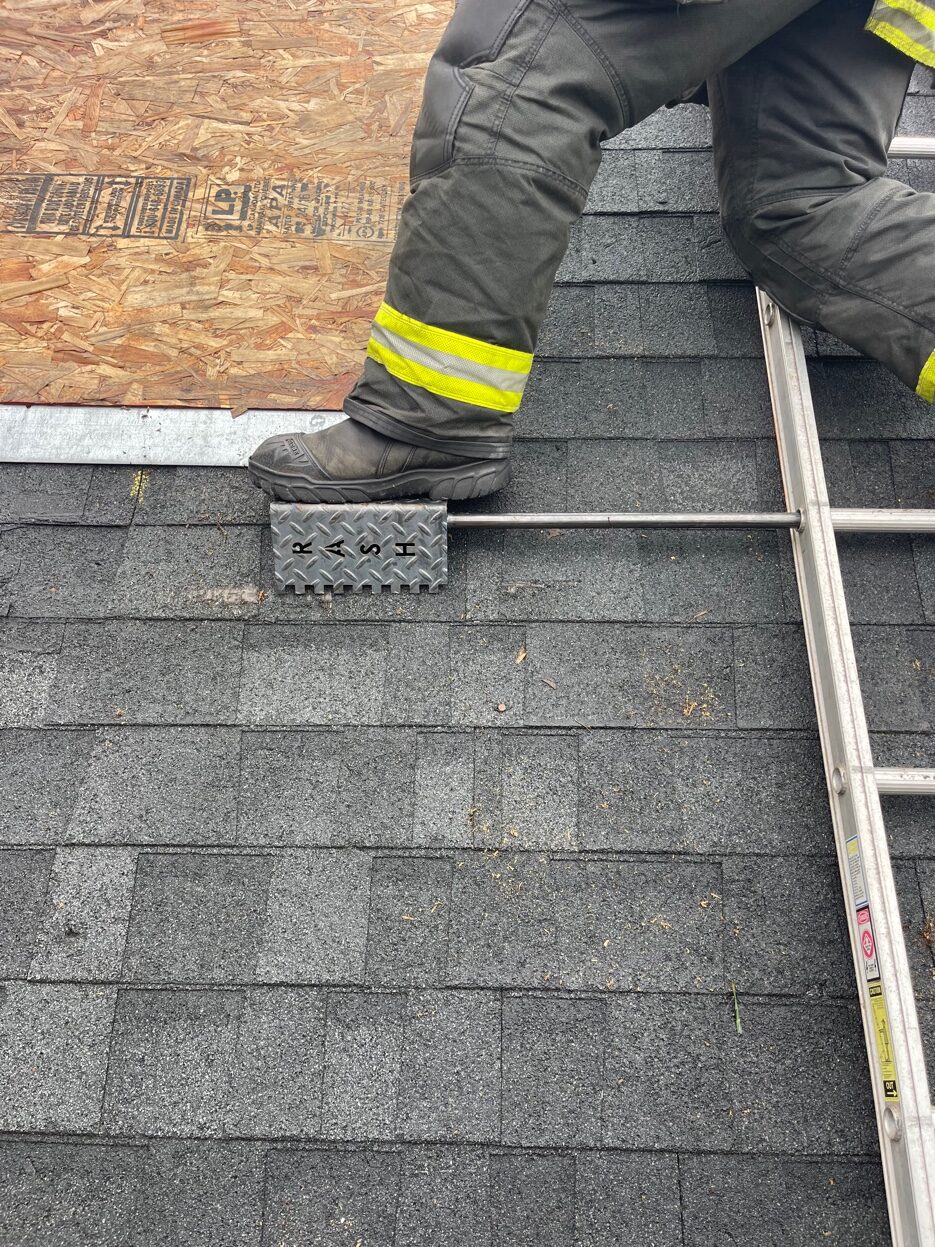 Firefighter using the Rash Bar during vertical ventilation on a roof